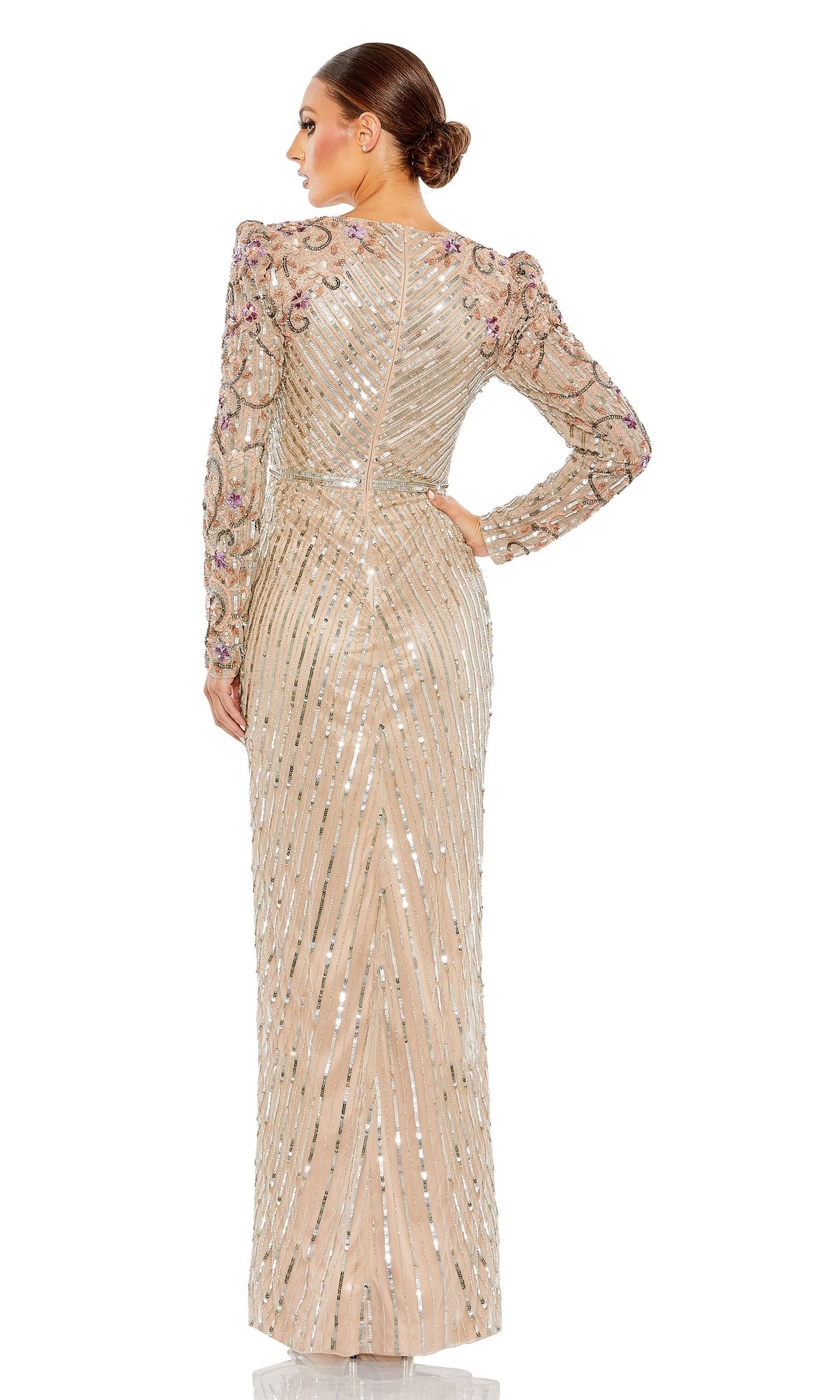 A woman stands with her back to the camera wearing the Long Formal Dress 5628 by Mac Duggal, a nude gown featuring sequins, floral shoulder embellishments, and long sleeves for an elegant, formal look.